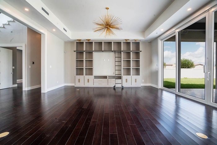 Interior room with wooden floor and view to backyard