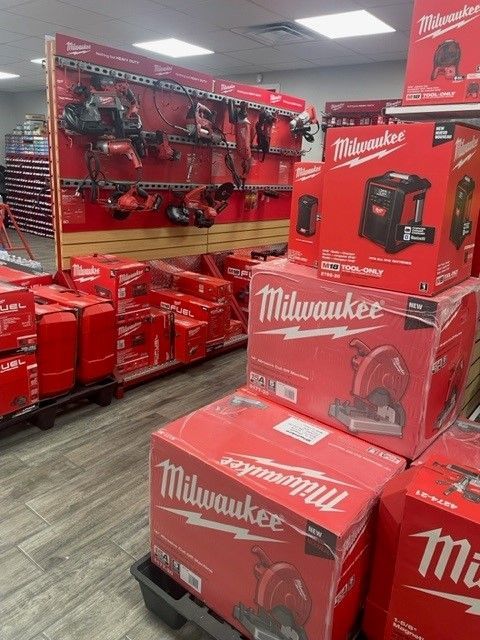 A store filled with lots of red boxes of milwaukee tools.