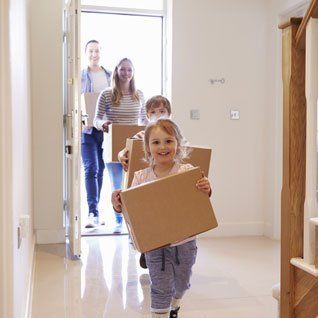 Young family entering home image