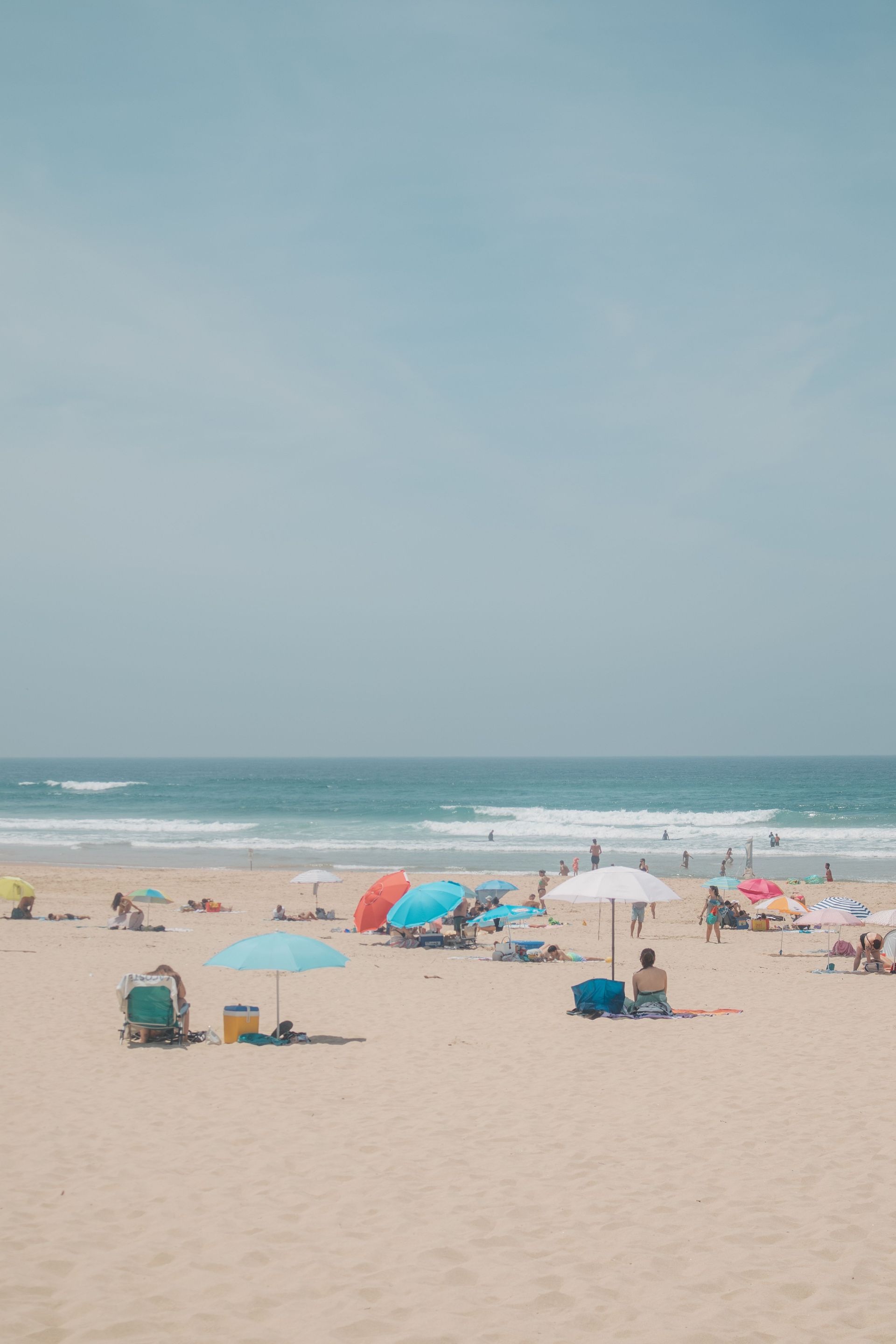 Summer umbrellas and people on the beach.