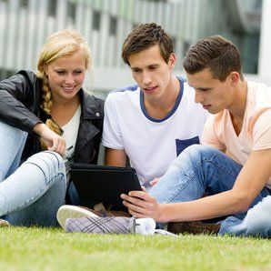 Younger generation relaxing on grass image