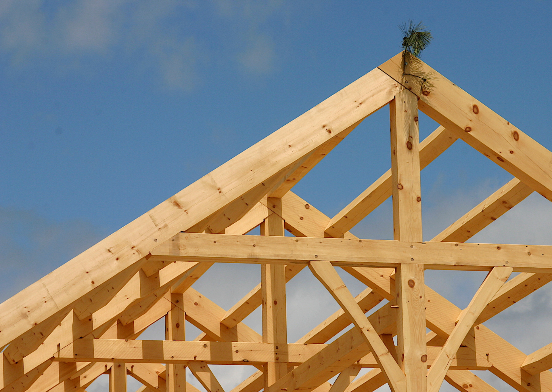 A wooden structure under construction with a blue sky in the background