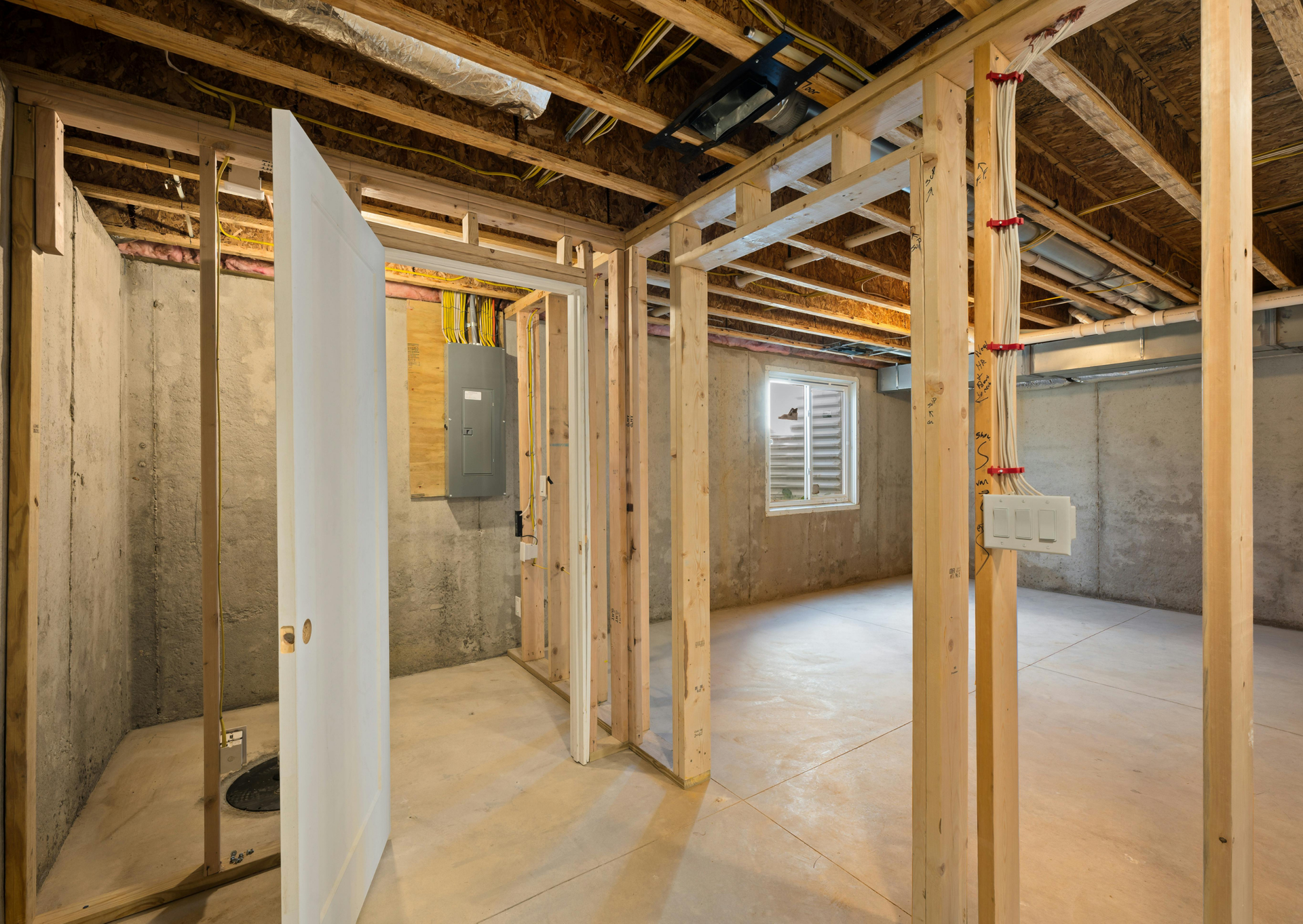 A basement under construction with wooden beams and doors.