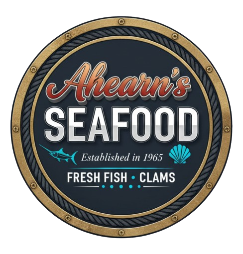 Round logo for Ahearn's Seafood, established 1965. Features text, a marlin, and a shell on a navy and gold background.