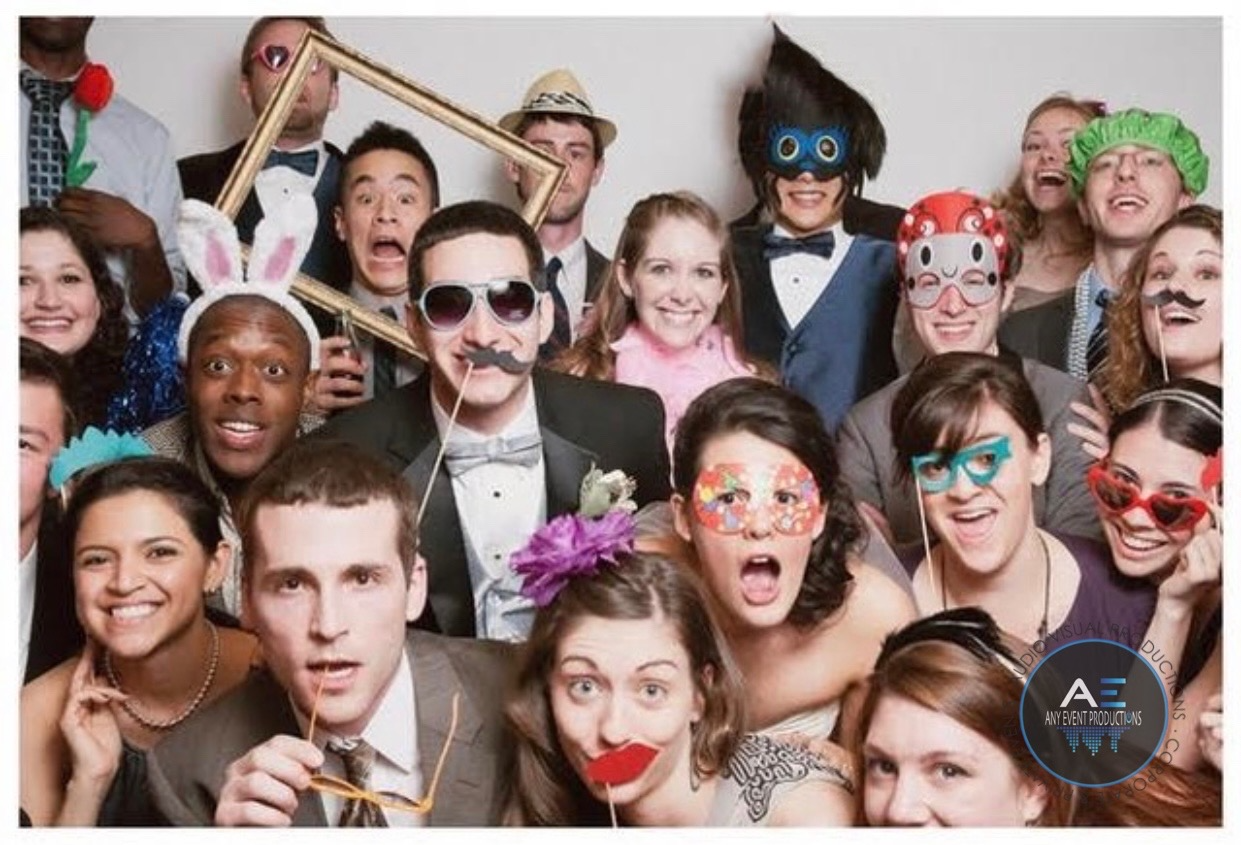 A group of people are posing for a picture in a photo booth.
