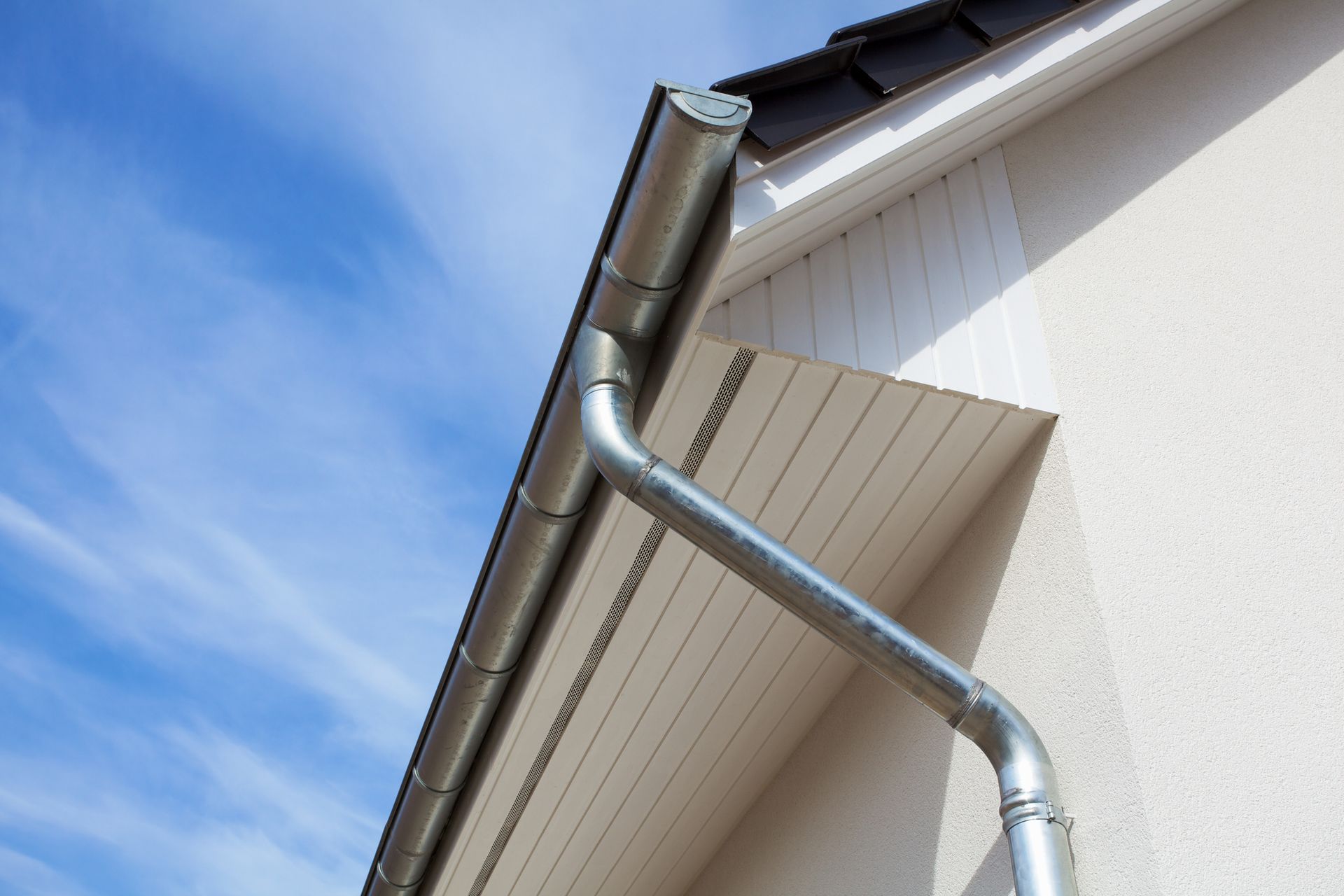 A close up of a gutter on the side of a house A close up of a gutter on the side of a house