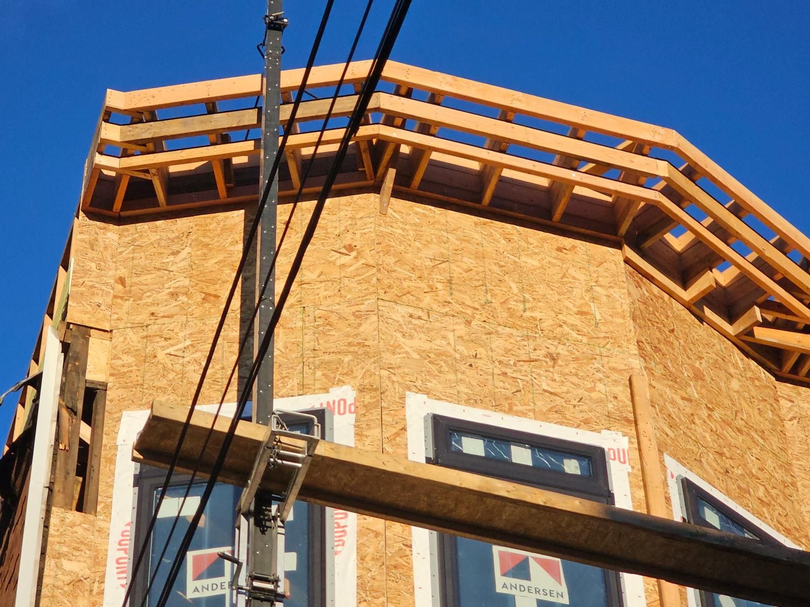 A building under construction with a forklift attached to it