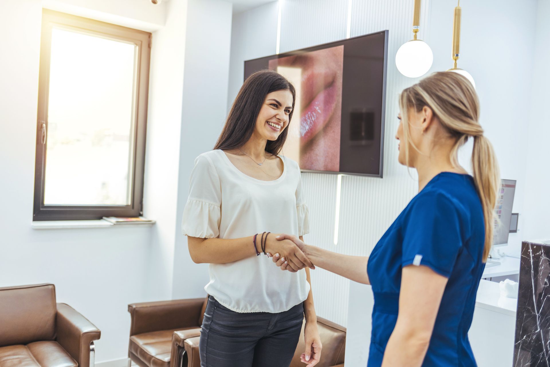 A close up of a woman 's mouth with her hair blowing in the wind.