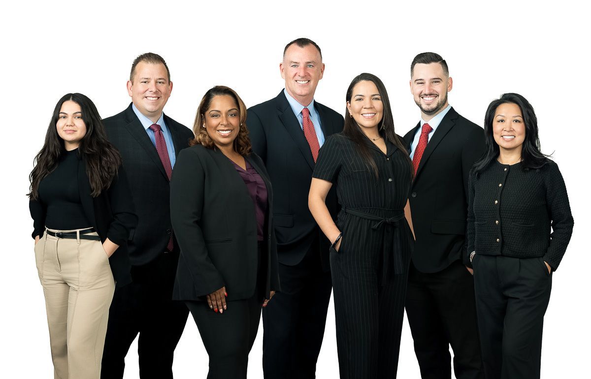 A group of people in suits and ties are posing for a picture.