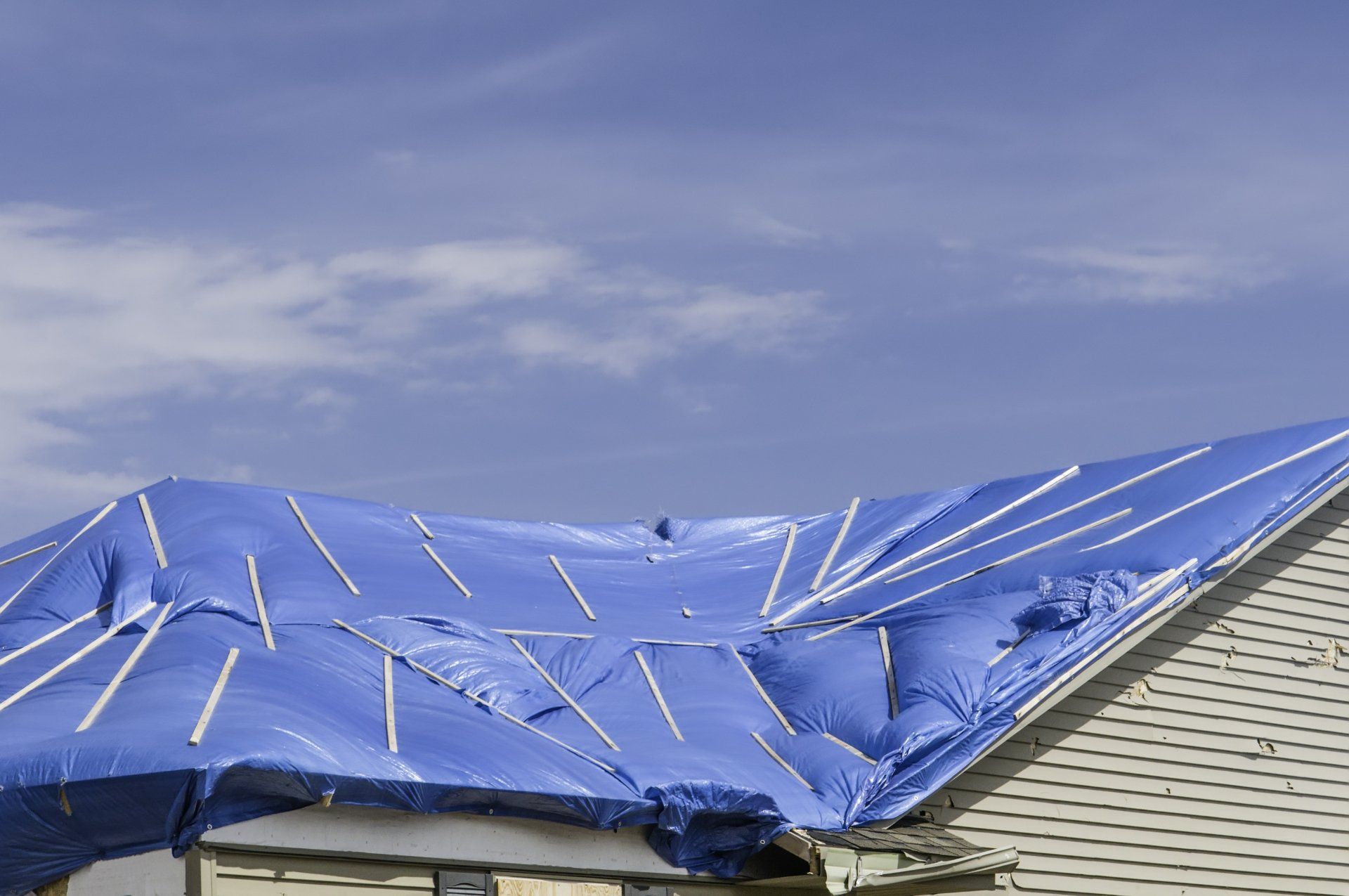 Tarp over roof of house