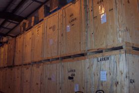 a warehouse filled with wooden crates labeled larkin