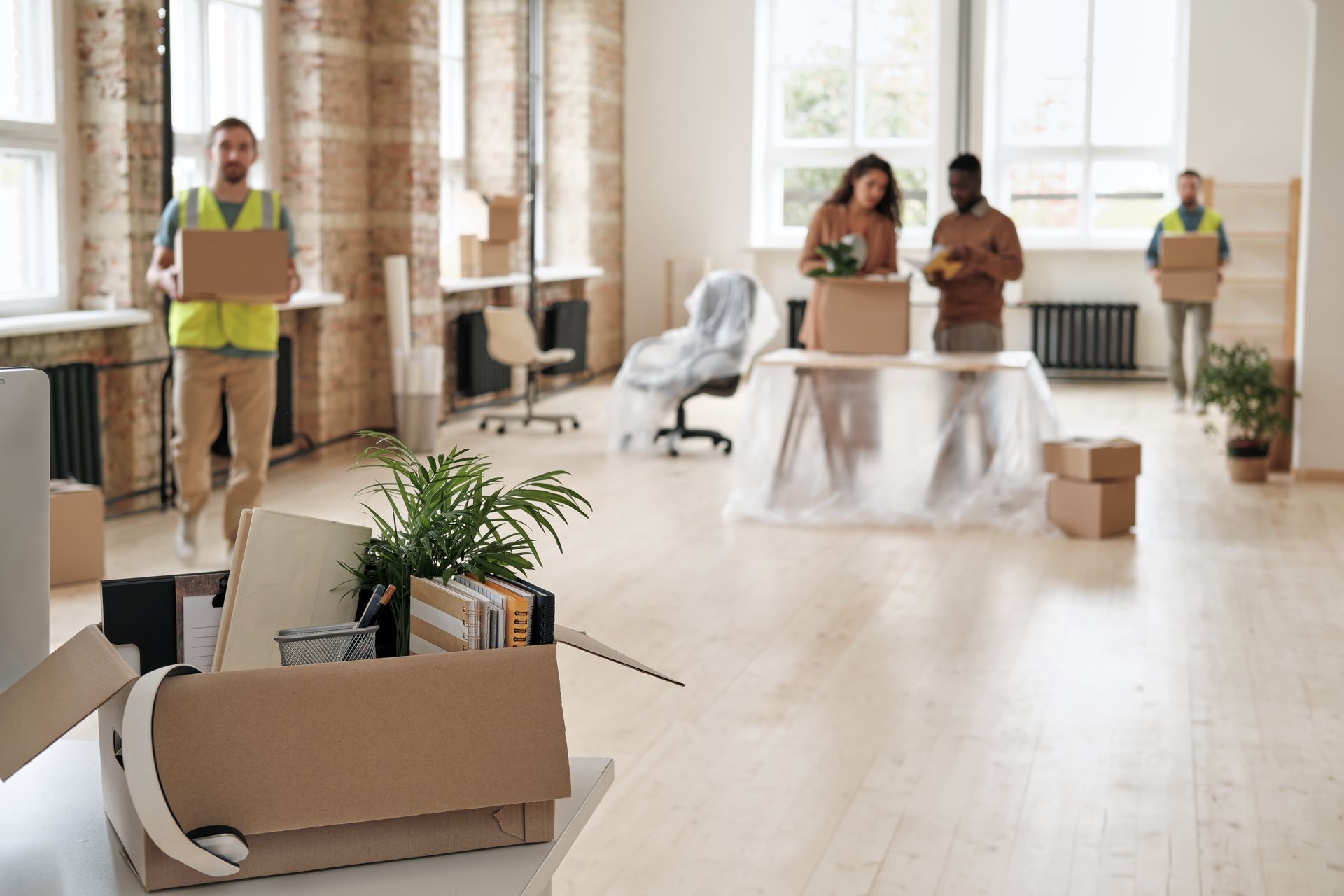 a group of people are moving into a new office