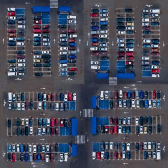 an aerial view of a parking lot with lots of cars