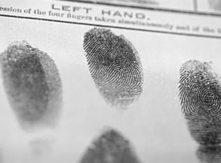 A black and white photo of fingerprints on a piece of paper.