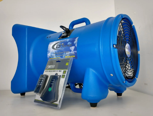 A blue industrial floor fan sits next to a packaged remote control kit on a white surface.
