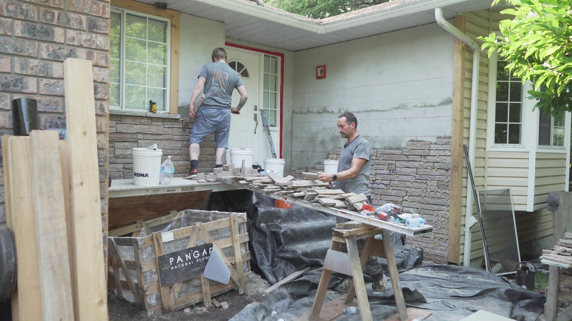 Chris the owner of Bricked Masonry and is helper are working on a stone veneer wall for a residential house in Vancouver, BC.