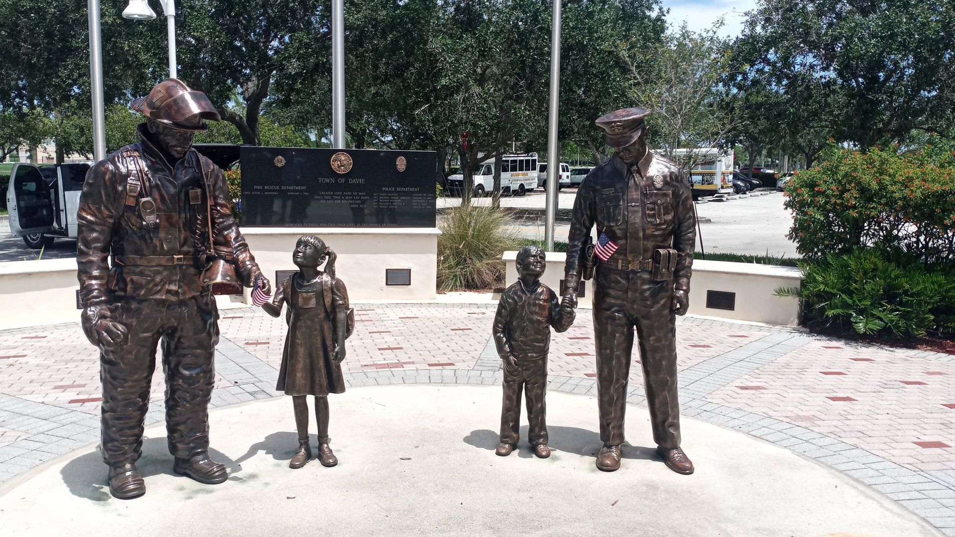 A statue of a fireman a police officer and two children