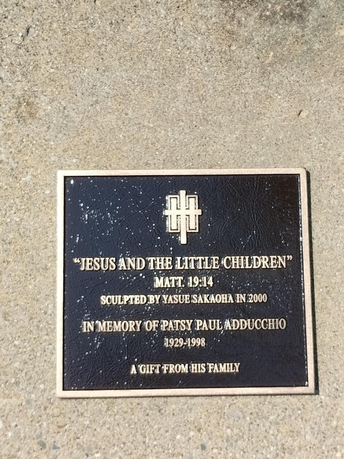 A plaque that says jesus and the little children on it