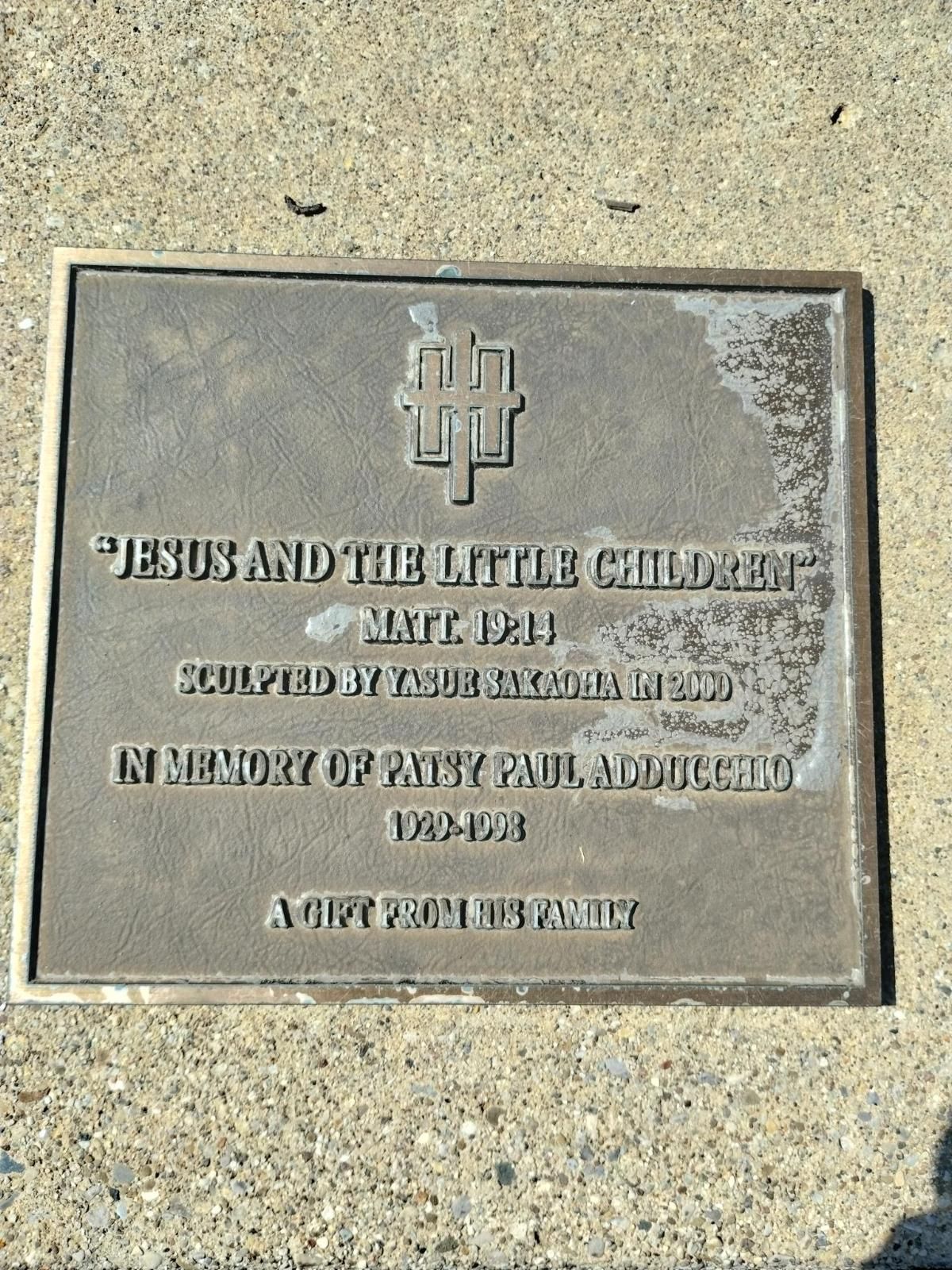 A plaque that says jesus and the little child on it