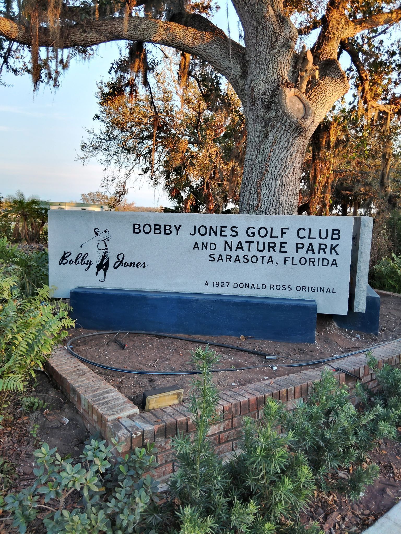 A sign for the ecnjy jones golf club and nature park