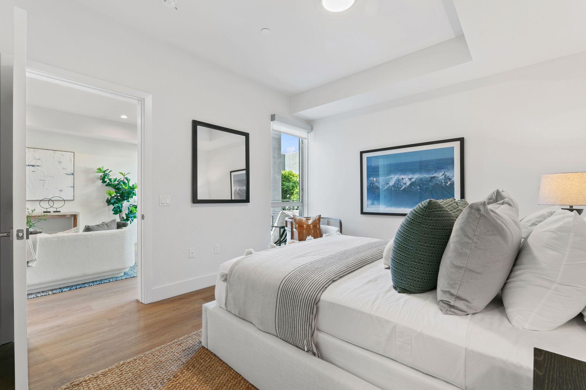 photo of a bedroom showing the entrance to the room and a corner window