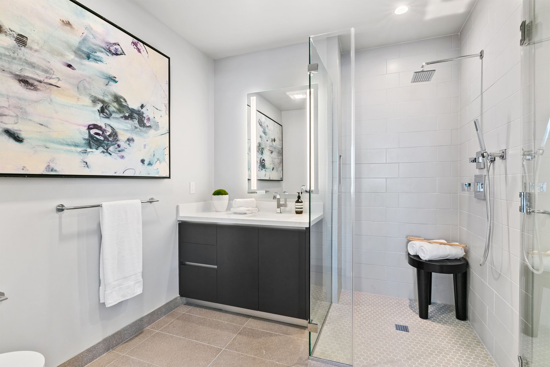 Photo of a walk-in shower and bathroom countertop