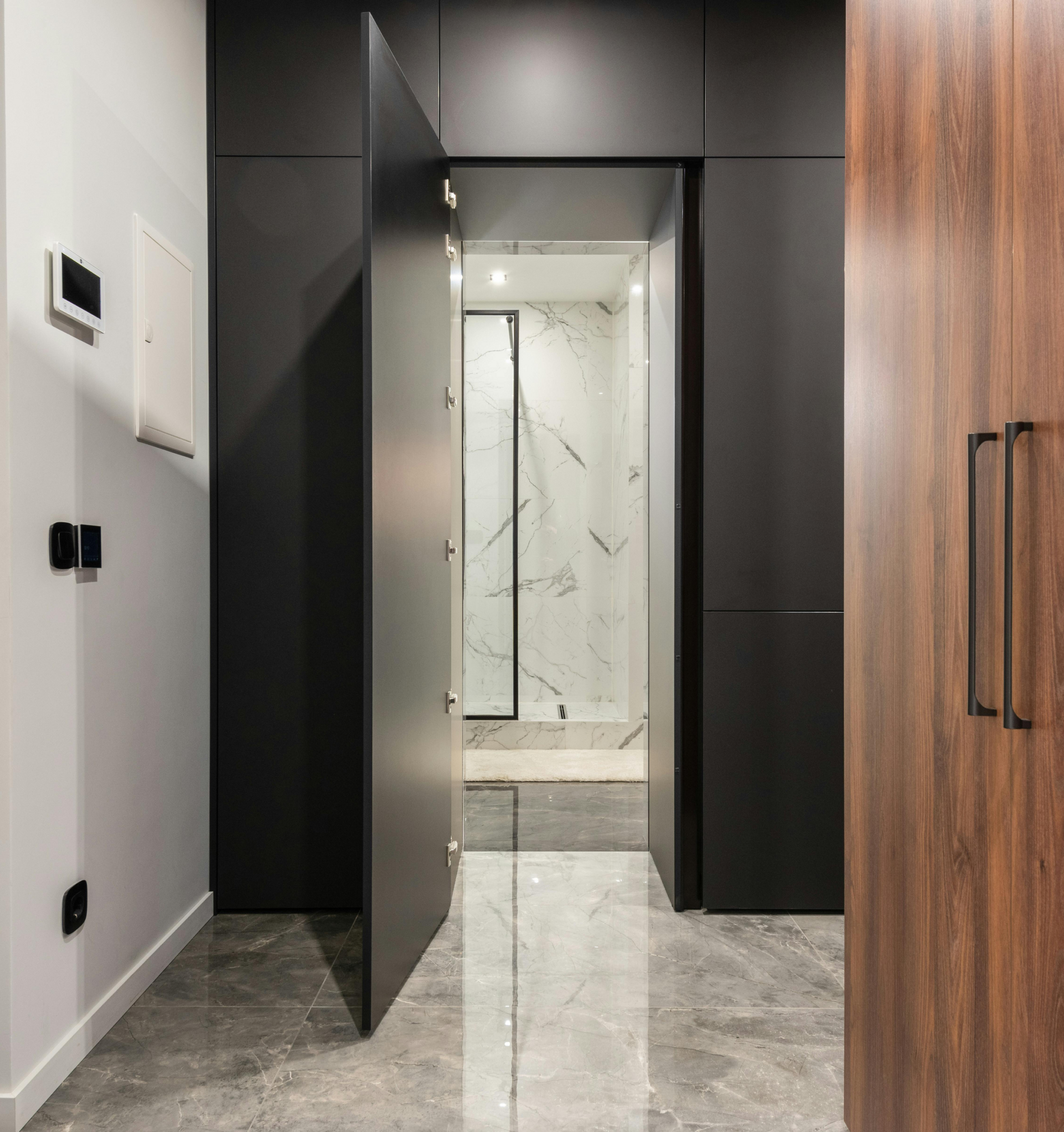 A hallway with a sliding door leading to a bathroom.