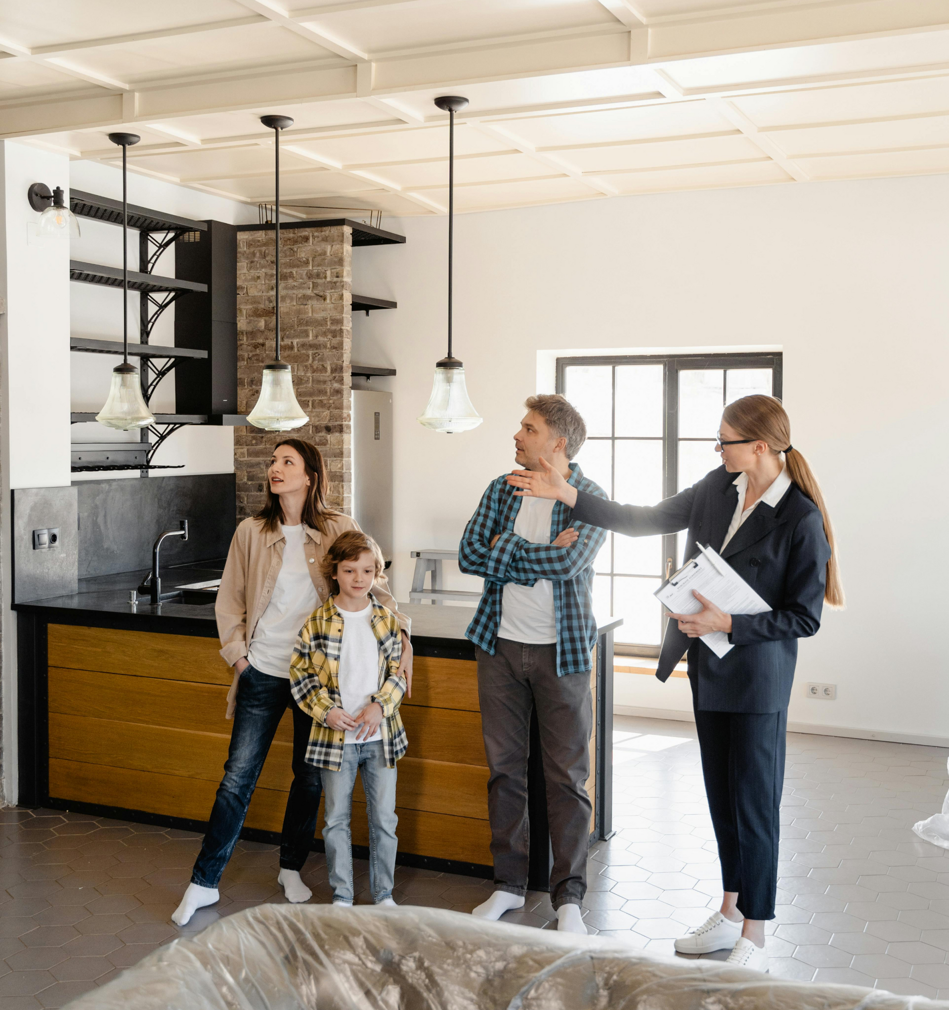 A group of people are standing in a living room looking at a house.