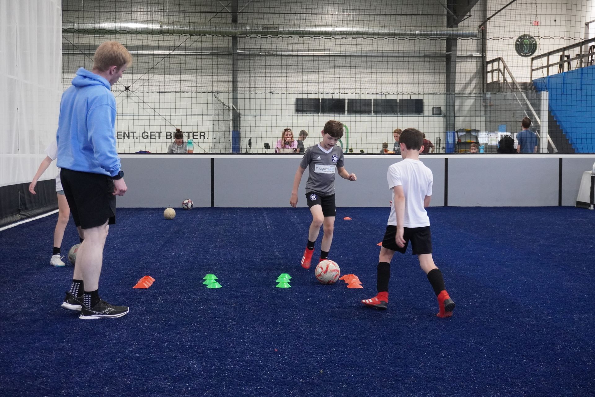 A group of young boys are playing soccer on a field.