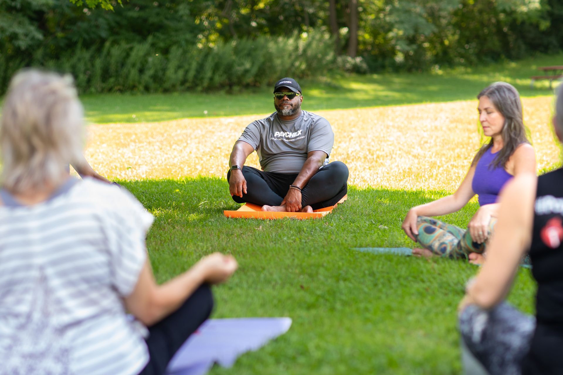 outdoor corporate yoga class with man and woman