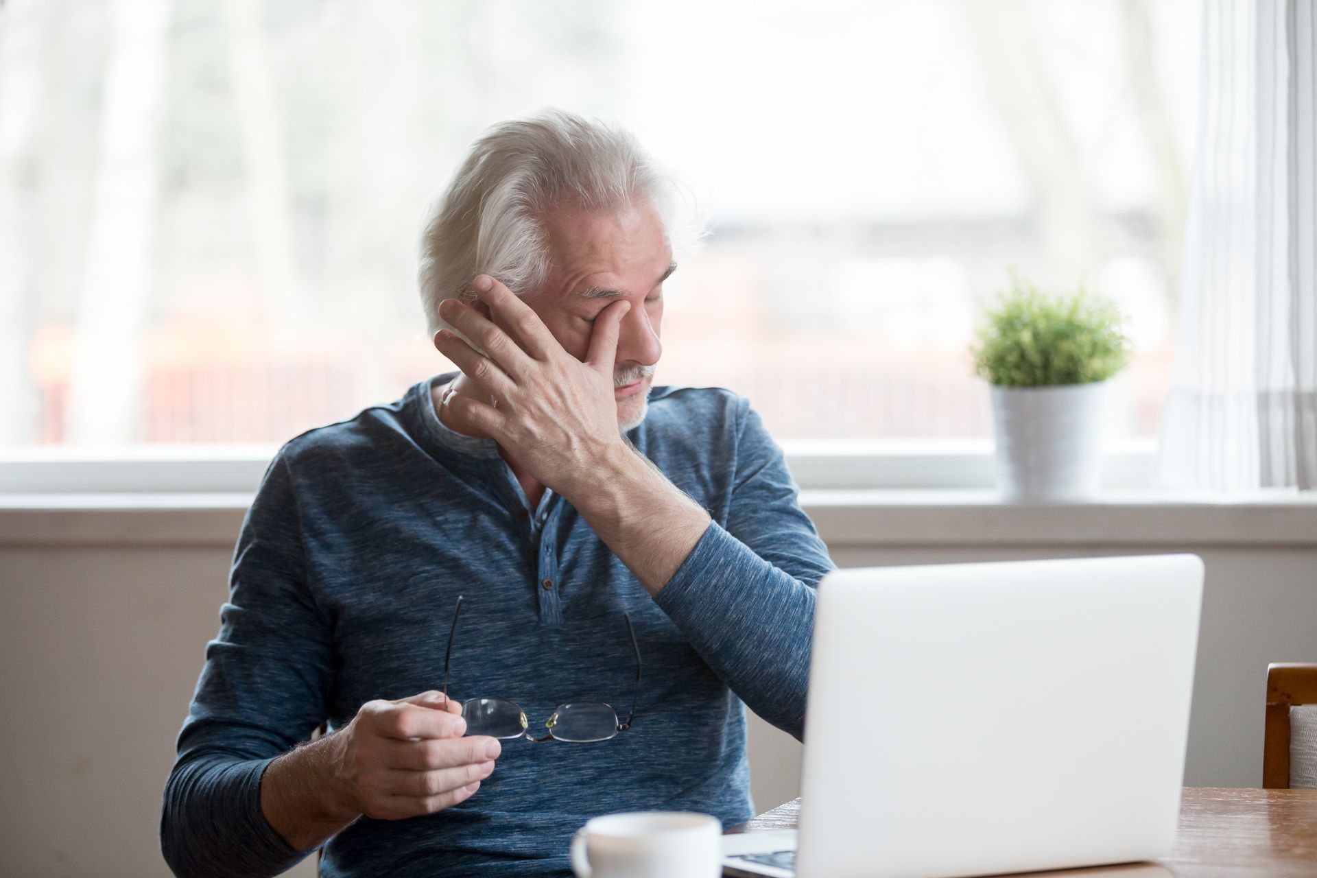 man with dry eye disease rubbing his eyes 