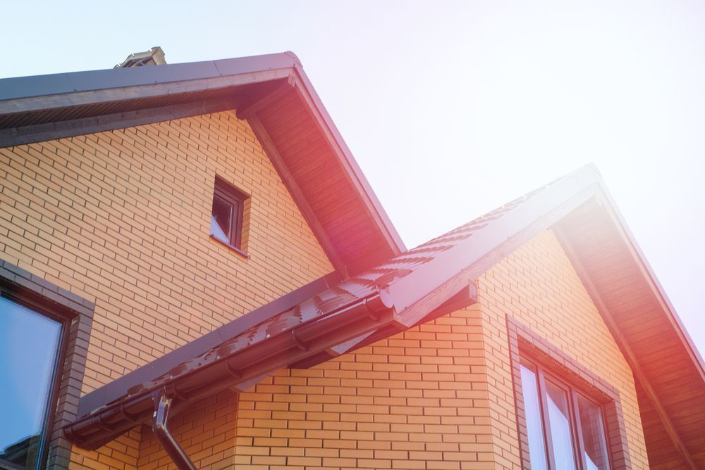 A Brick House With A Black Roof And A Lot Of Windows — Asbestos Risk Removal In Mackay, QLD