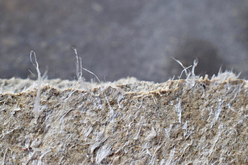 A Close Up Of a Piece of Concrete with A Lot of Dust on It — Asbestos Risk Removal In Gladstone, QLD