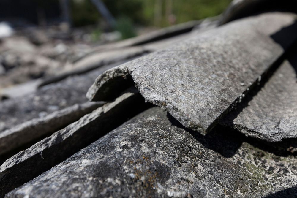 A Close up Of a Piece of Concrete on A Roof — Asbestos Risk Removal In Mackay, QLD