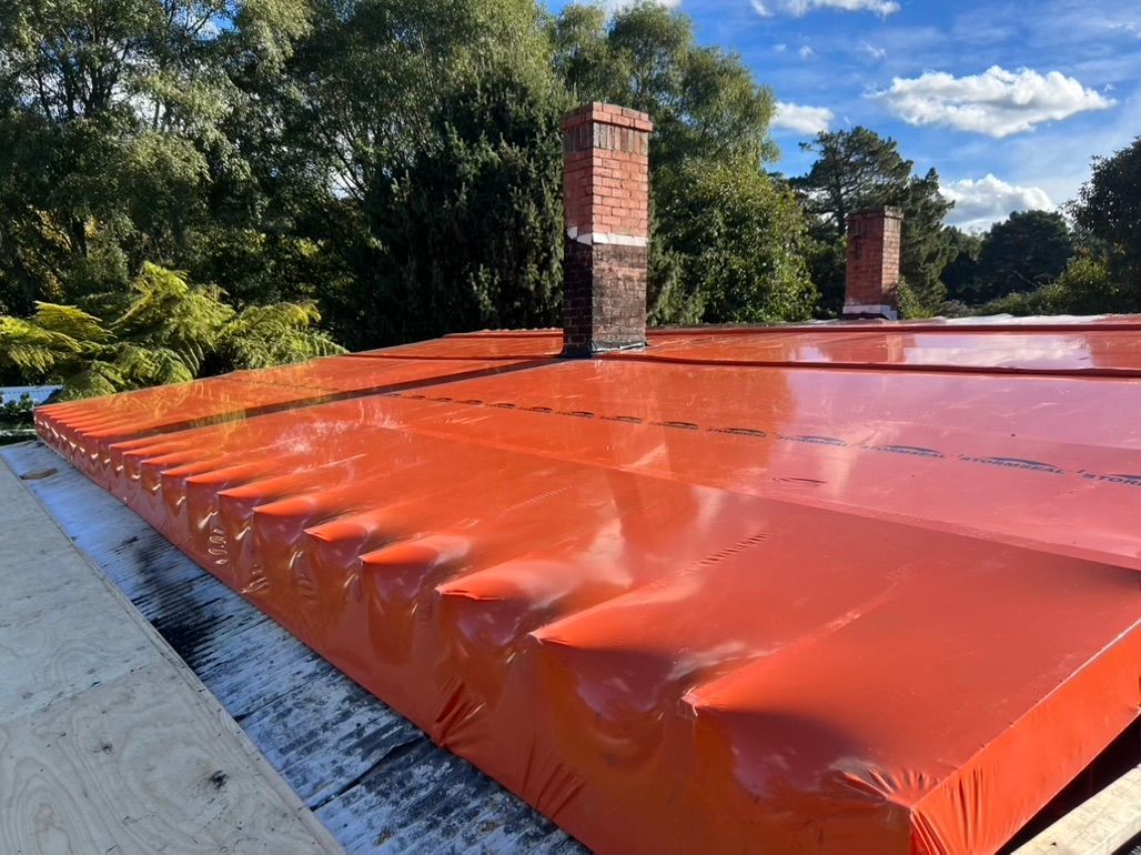 A House with A Red Seal on The Roof — Asbestos Risk Removal In Rockhampton, QLD