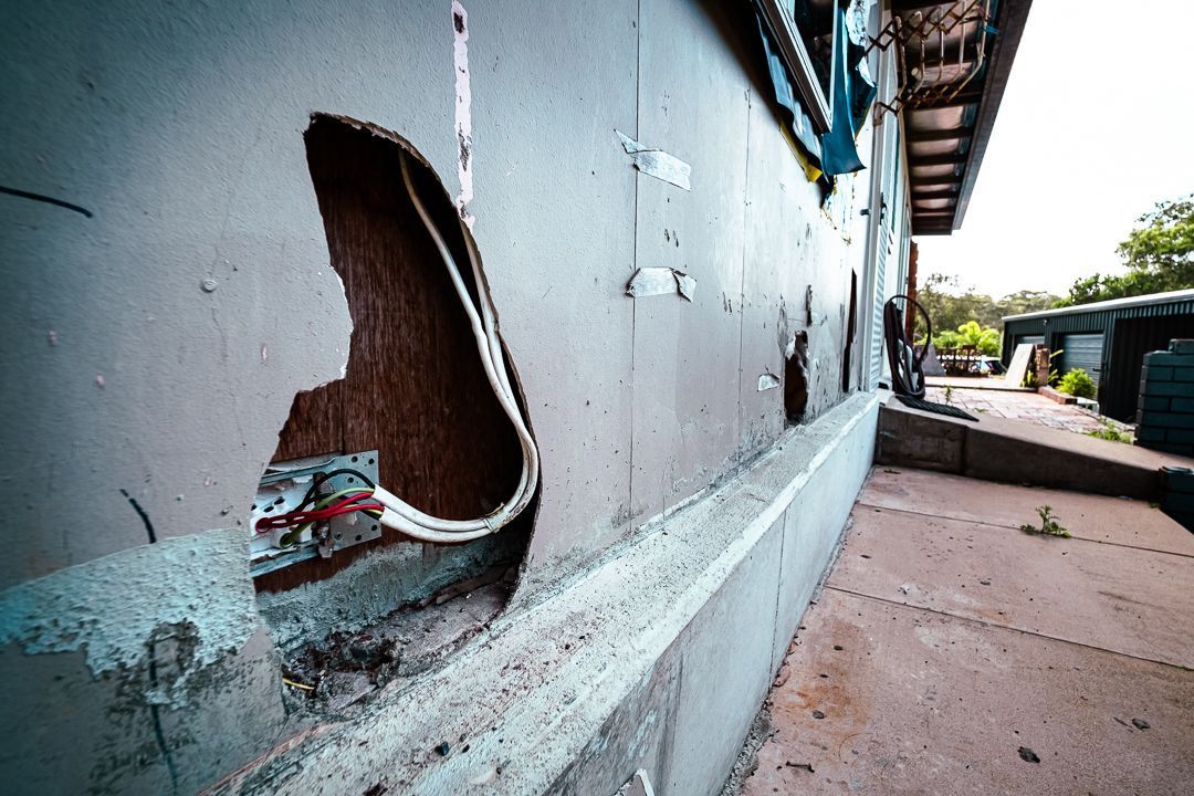 Two Men Wearing Gas Masks Are Working on A Roof — Asbestos Risk Removal In Rockhampton, QLD