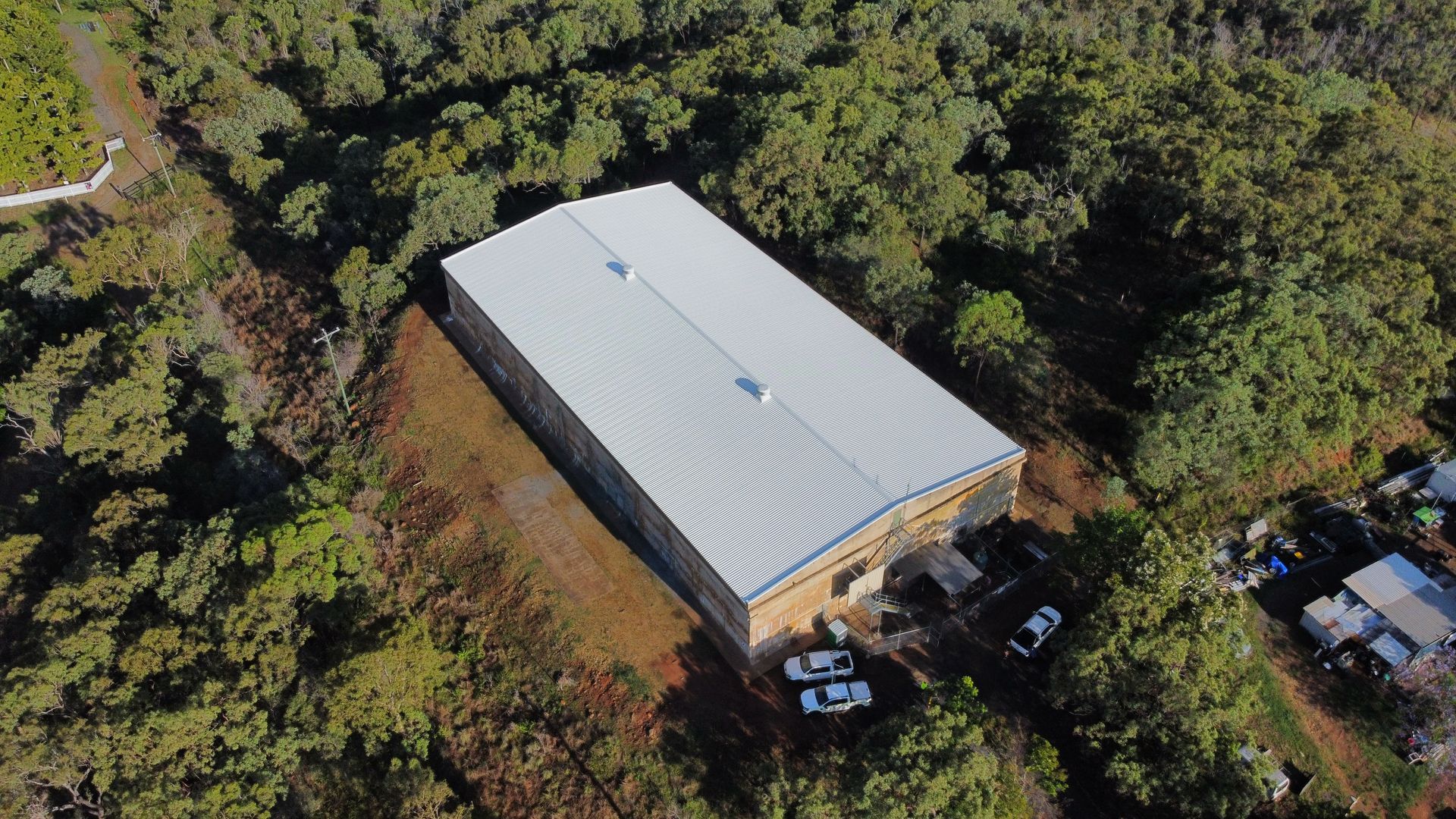 A Man In A Protective Suit Is Kneeling Down — Asbestos Risk Removal In Mackay, QLD