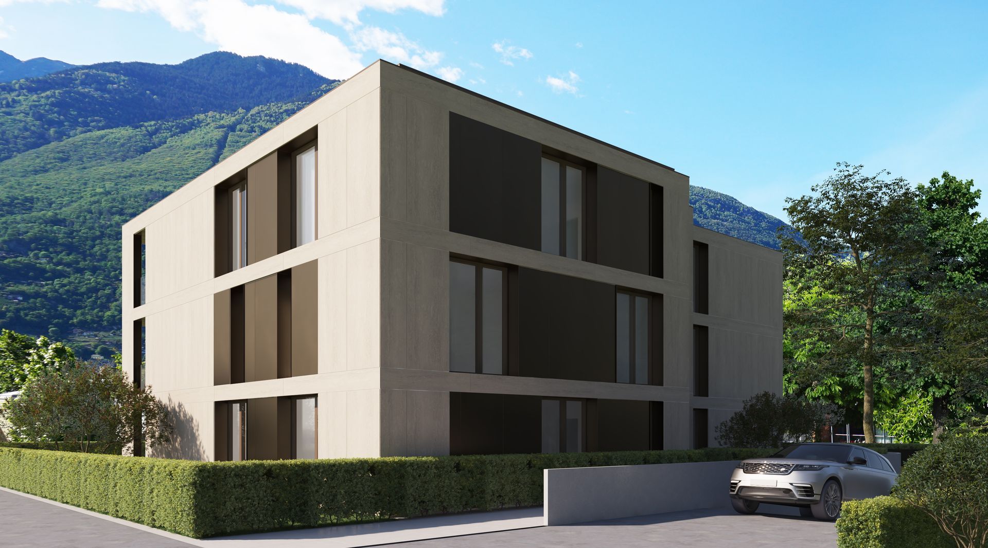 Un'auto sta uscendo da un garage di un edificio con le montagne sullo sfondo