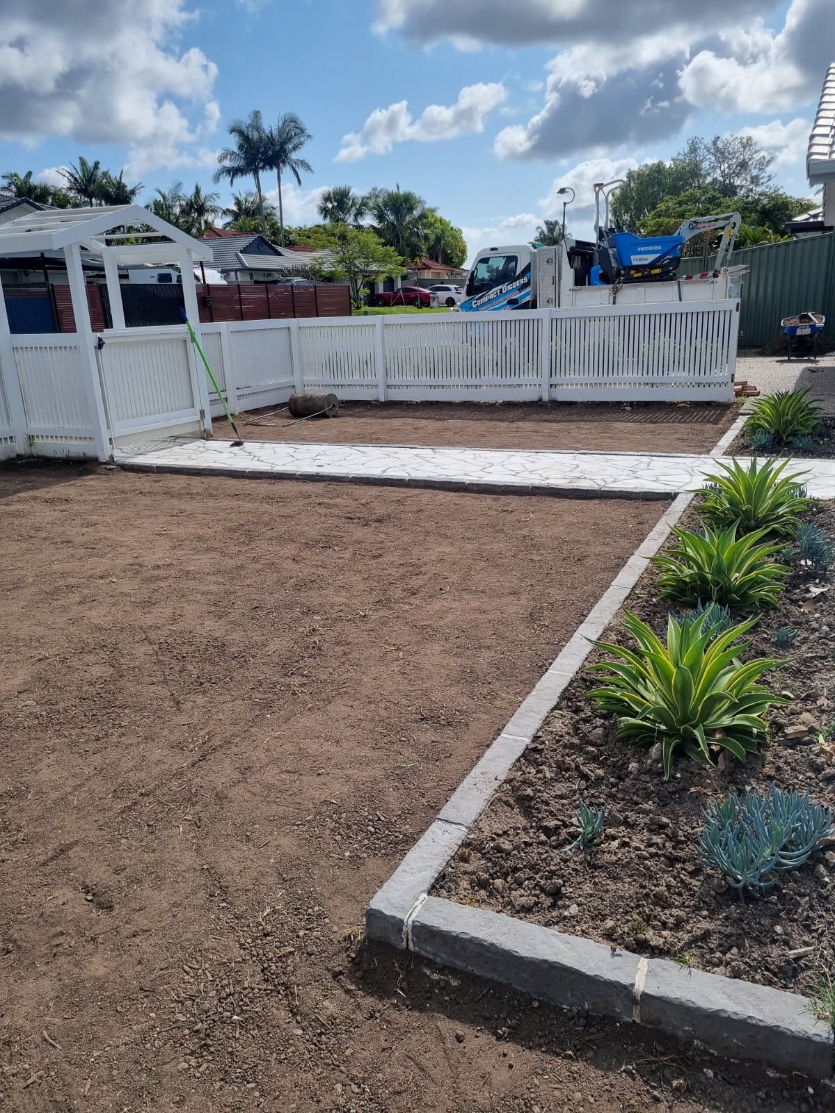 A Yard With White Picket Fence — Coastline Earthworks in Helensvale, QLD