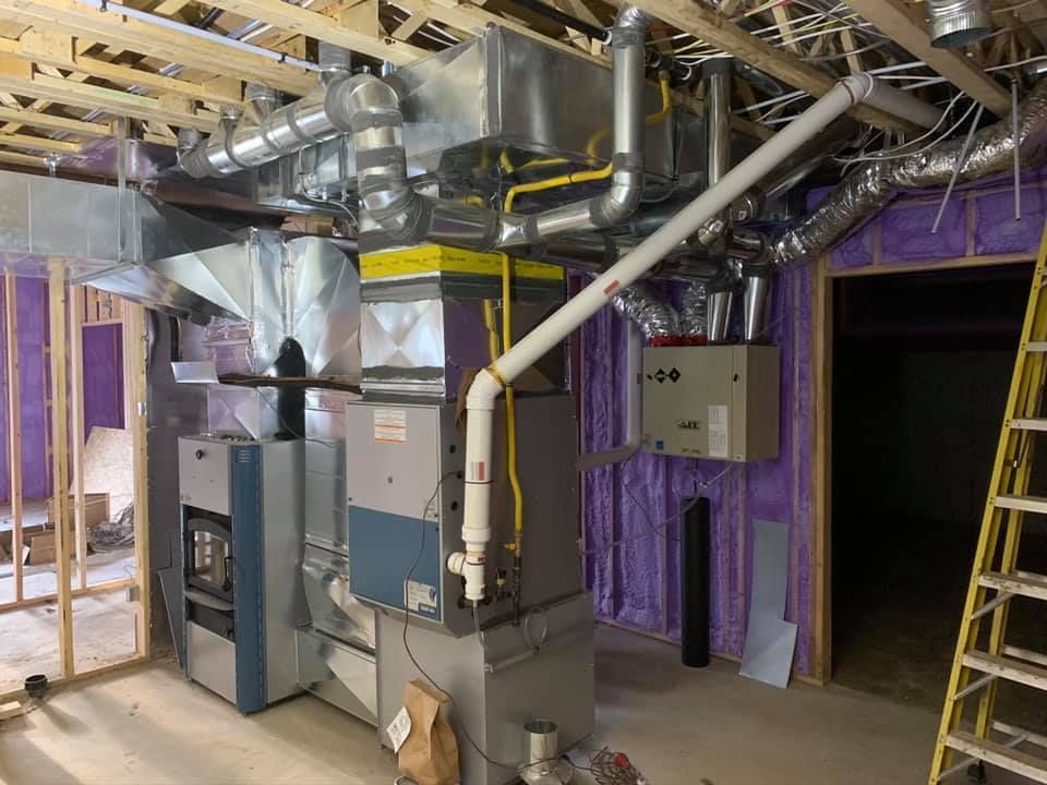 HVAC system in basement with ductwork, furnace, and water heater installation.