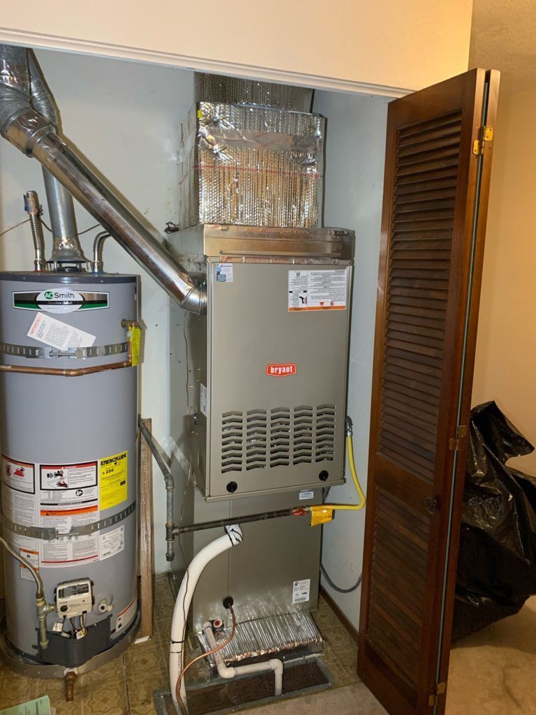 Water heater and Bryant furnace in a utility closet