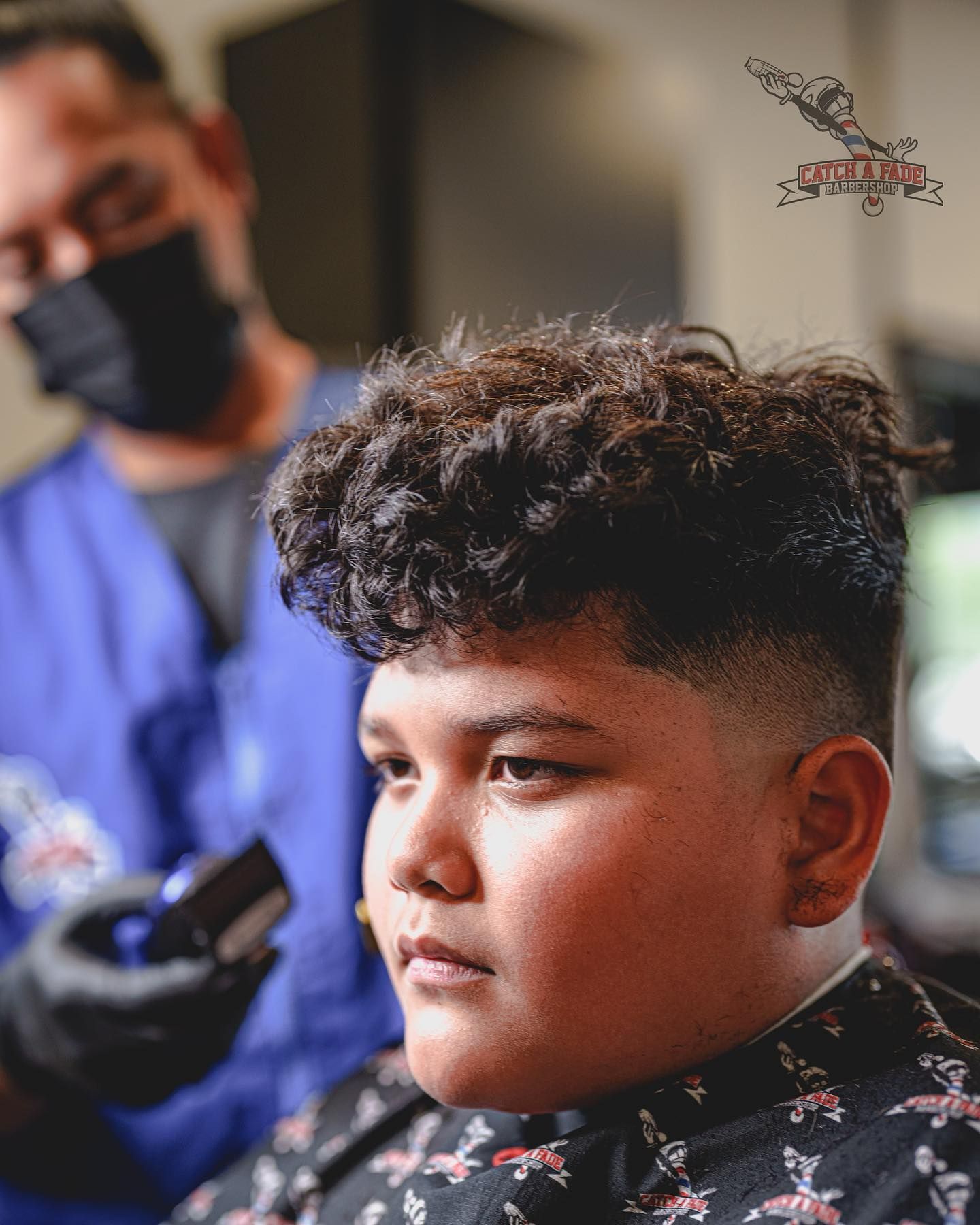Person getting a haircut. Barber with a mask and black gloves.