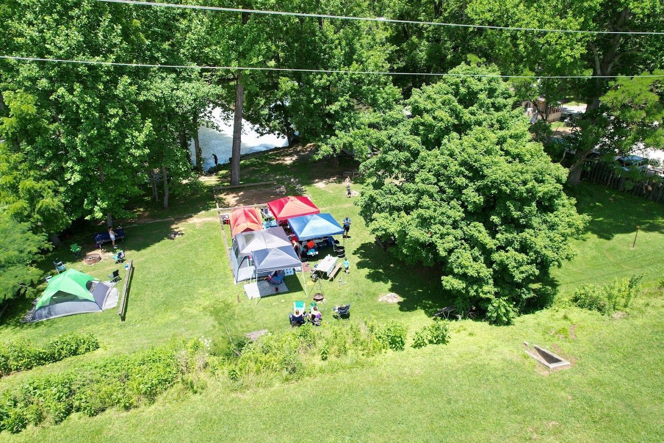 A group of tents are sitting on top of a lush green field.
