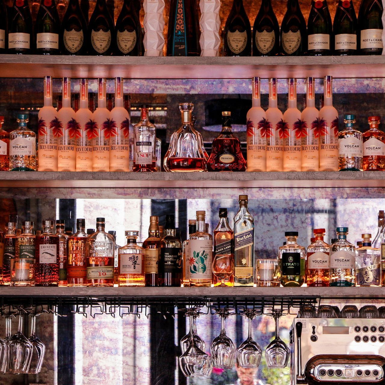 neatly organized bar with various spirits