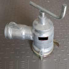 A metal valve with a handle is sitting on top of a black mat.