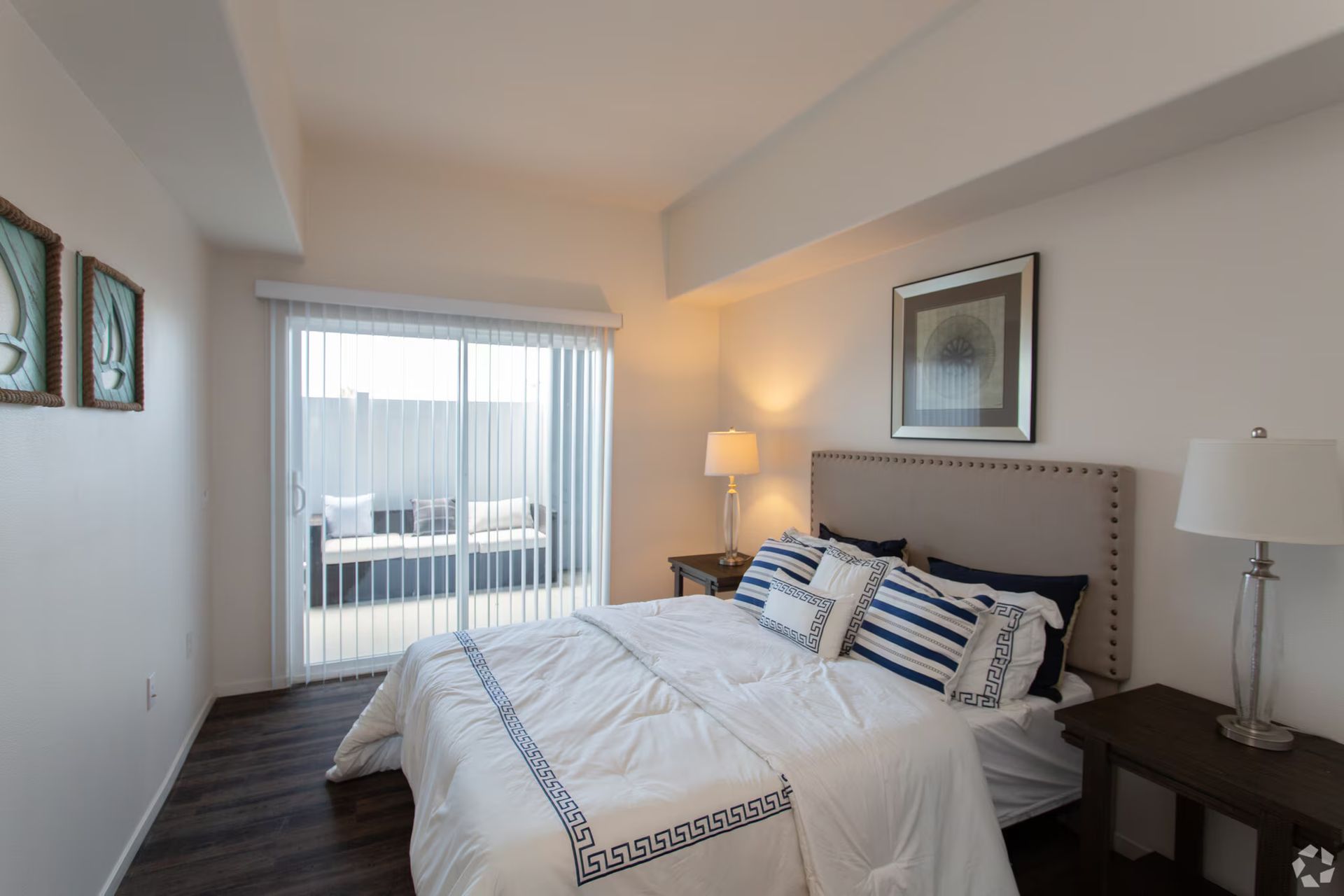 Photo showing a bedroom with a sliding glass window and a patio outsid