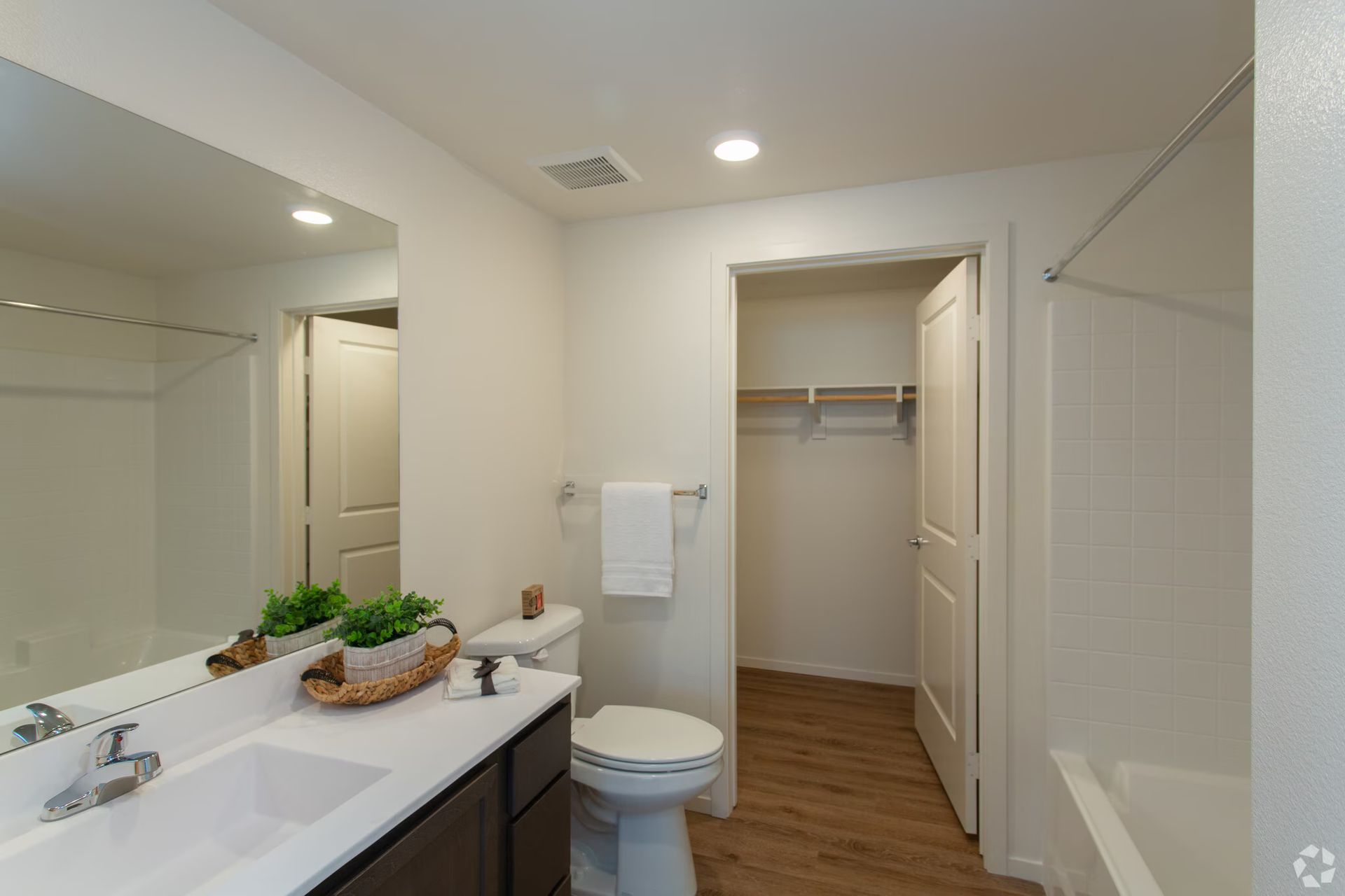Photo showing a bathroom with a shower/tub combo and a walk-in closet