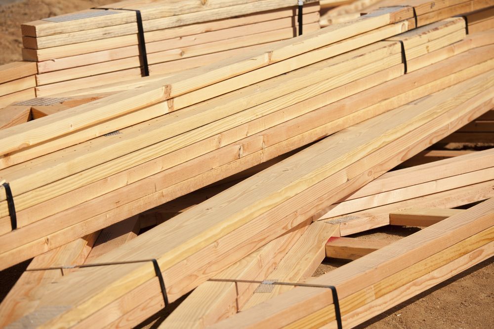 Wooden Construction Beams Stacked Outdoors — Premium Trusses In South Grafton, NSW