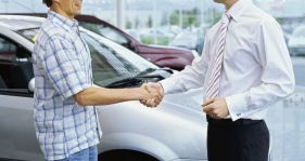 Mechanic and car owner shake hands