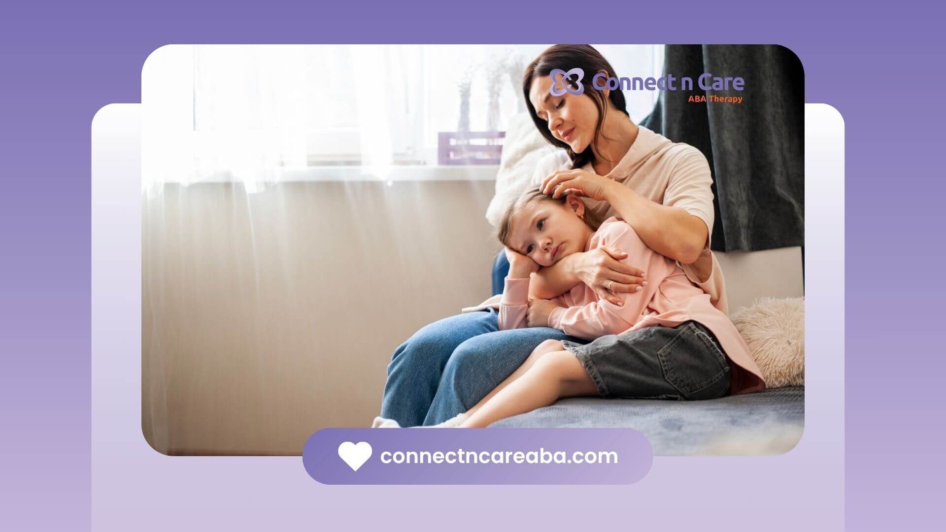 A BCBA is sitting on a couch holding a little girl in ABA therapy.